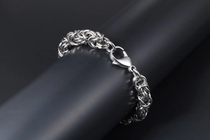 Detail of silver byzantine weave stainless steel bracelet with large lobster clasp