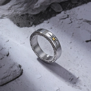 Macro detail of vintage steel ring with sunburst motif and engraved scrollwork sides