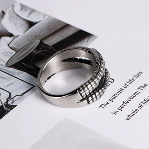 Close-up of vintage stainless steel dragon claw ring with textured scale pattern