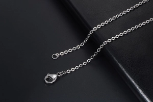 Detailed close-up of a silver titanium steel O-chain necklace with a secure lobster clasp