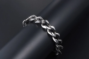 Detailed macro view of a silver-toned thick curb chain bracelet for men on display