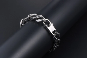 Polished silver cuban link chain bracelet detail with industrial lobster clasp for men