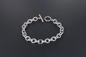 Macro detail of silver titanium steel chain bracelet with a classic minimalist OT toggle clasp