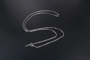 Detailed view of stainless steel O-chain necklace with lobster clasp on black background