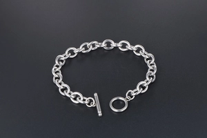 Detail of silver titanium steel chain bracelet with a classic minimalist OT toggle clasp