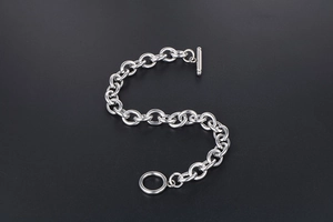 Detailed macro view of a silver titanium steel chain bracelet with a classic T-bar OT clasp