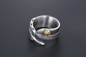 Macro shot of vintage feather open ring with detailed eagle emblem in silver finish