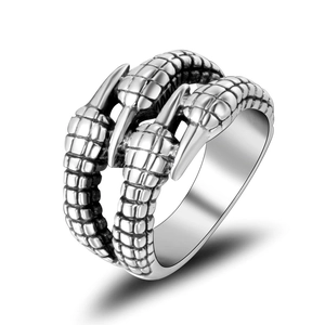 Macro detail of retro dragon claw ring featuring realistic scale textures and silver finish