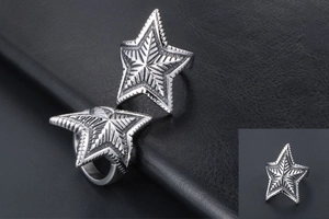 Macro shot of retro star ring for men featuring industrial engraved lines on aged steel