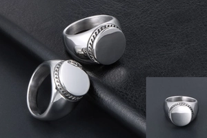 Detail of silver titanium wide rings for men featuring woven textured edges on black leather