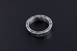 Detailed macro view of retro titanium steel ring with sunburst and scroll pattern