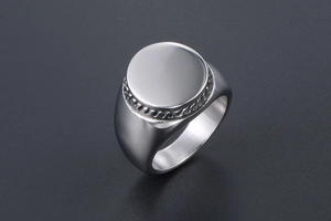 Macro shot of polished silver signet ring with engraved rope border and flat mirror top