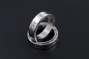 Detailed macro view of vintage sunflower starburst engraving on stainless steel ring