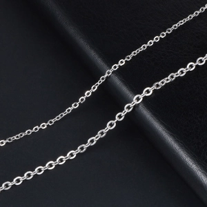 Polished silver titanium steel O-chain necklace on black leather jewelry stand