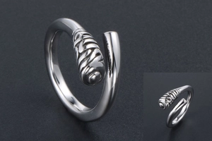 Macro detail of silver titanium steel ring featuring spiral texture and polished finish