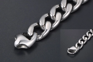 Close-up of polished titanium steel curb link bracelet featuring a durable lobster clasp