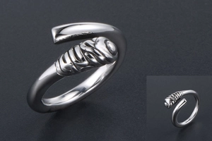 Macro detail of silver titanium steel ring featuring textured wrap design and smooth finish