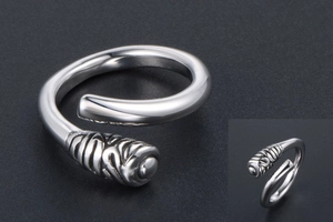 Macro detail of silver titanium steel ring featuring spiral texture and polished finish