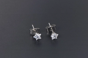 Detail view of star-shaped titanium steel stud earrings with white zircon inlay