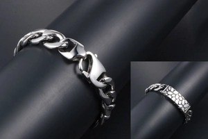 Macro view of pebble-textured stainless steel bracelet with a sturdy lobster clasp
