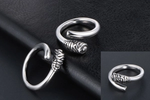 Detail of vintage silver titanium steel open rings with intricate carved textures