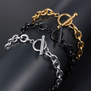 Three minimalist titanium steel chain bracelets in gold, black, and silver with OT toggles