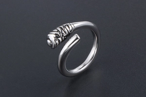 Macro shot of silver titanium steel ring with ribbed texture and wrapped wire design