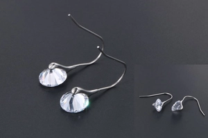Detailed view of silver hoop earrings with round multi-faceted sparkling crystals