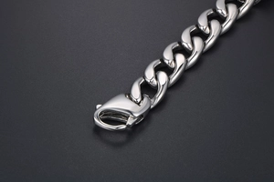 Macro detail of high-polish steel Cuban link bracelet with secure lobster clasp
