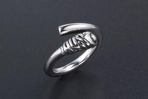 Macro detail of adjustable steel ring featuring a spiral textured end and polished finish
