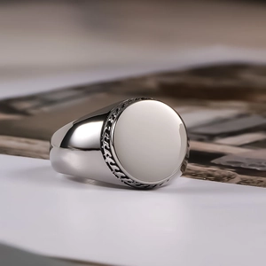 Modern wide titanium steel signet ring for men with polished circular face and braided texture