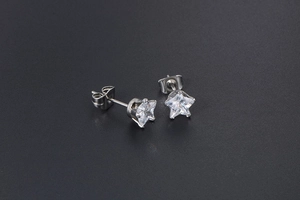 Macro shot of star-cut white cubic zirconia stud earrings with stainless steel butterfly backs