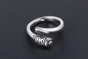 Detailed view of silver titanium steel ring featuring spiral texture and polished finish