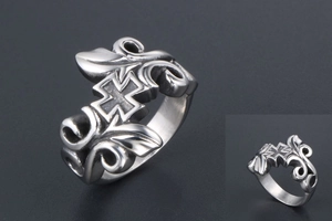 Macro view of vintage gothic cross ring with intricate floral vine relief in steel