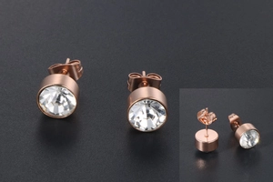 Detailed views of rose gold titanium earrings with round brilliant cubic zirconia stones