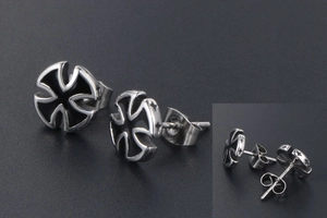 Macro detail of titanium steel cross earrings with black enamel inlay and star patterns