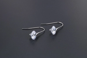 Close-up of elegant silver drop earrings with marquise-cut sparkling zircon stones