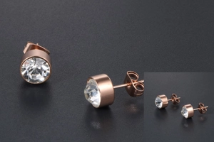 Macro detail of rose gold titanium steel stud earrings with round-cut sparkling crystals