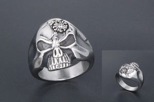 Macro view of vintage stainless steel skull ring with embossed forehead cross detail