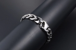 Macro detail of polished pebble texture titanium steel curb chain with lobster clasp