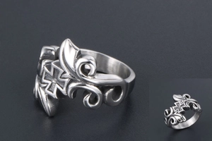Macro detail of vintage titanium steel ring showing gothic cross and floral engraving