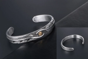 Detailed view of retro eagle feather cuff bracelet with golden central emblem