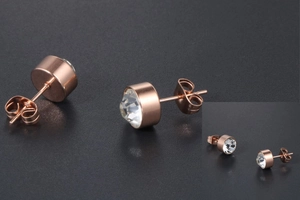 Close-up of rose gold titanium steel stud earrings with clear zircon and butterfly back
