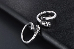 Detailed close-up of retro silver steel rings with spiral twist and embossed texture