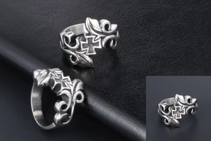 Detailed macro view of vintage titanium steel ring with gothic cross and floral patterns