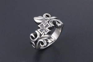 Macro view of vintage titanium steel ring with cross relief and floral vine carvings