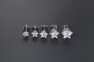 Detailed size comparison of five star-shaped zircon stud earrings in silver steel