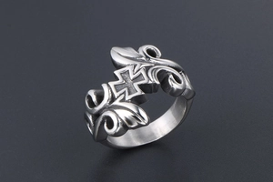 Close-up of vintage gothic cross ring in matte silver finish with intricate floral patterns