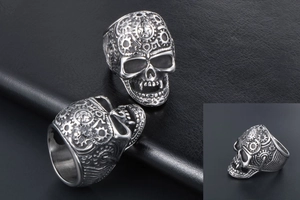 Macro detail of retro silver skull ring featuring steampunk mechanical gears and star motifs