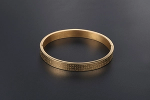 Macro detail of Heart Sutra micro-engraving on gold-plated stainless steel bracelet